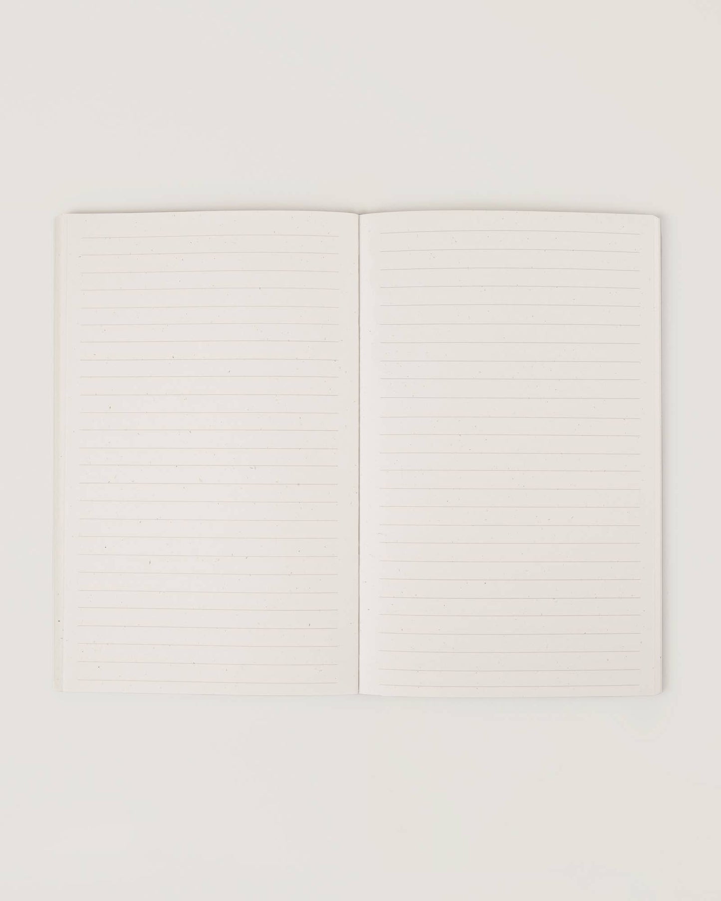 Cream-coloured minimalist journal titled “The Realist” with poetic zodiac references on the cover – a lined astrology-inspired notebook made with recycled paper.