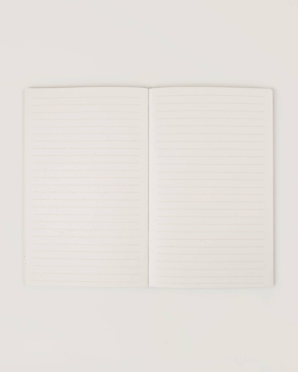 Cream-coloured minimalist journal titled “The Realist” with poetic zodiac references on the cover – a lined astrology-inspired notebook made with recycled paper.