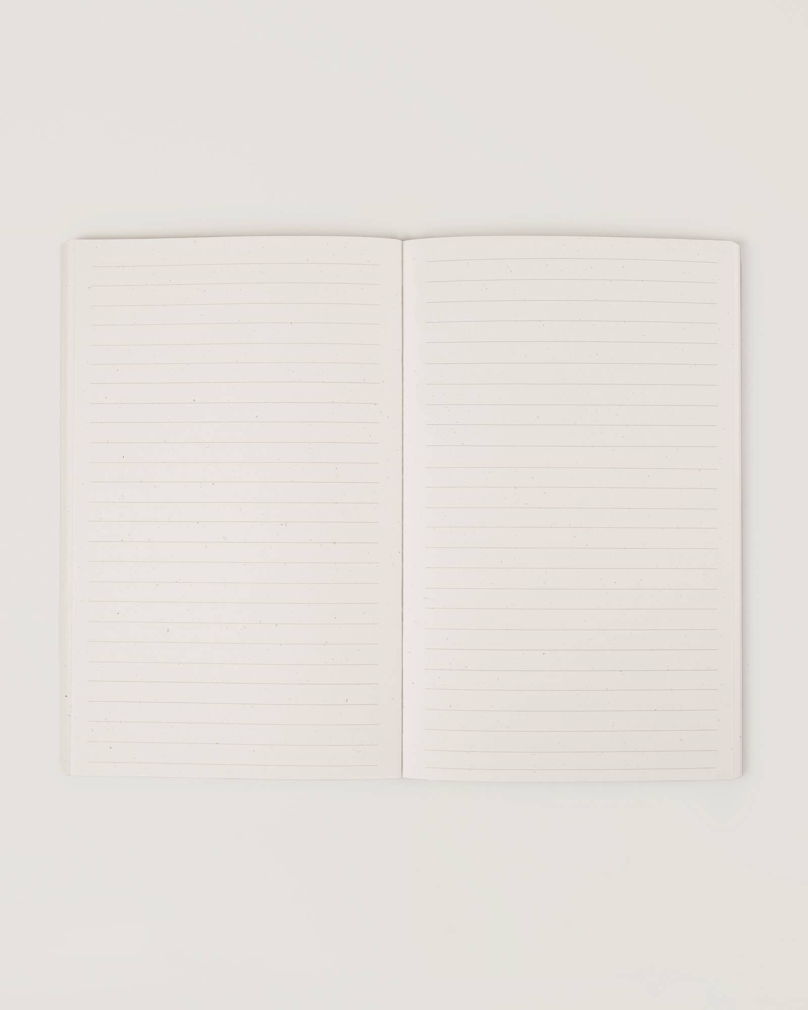 Cream-coloured minimalist journal titled “The Realist” with poetic zodiac references on the cover – a lined astrology-inspired notebook made with recycled paper.